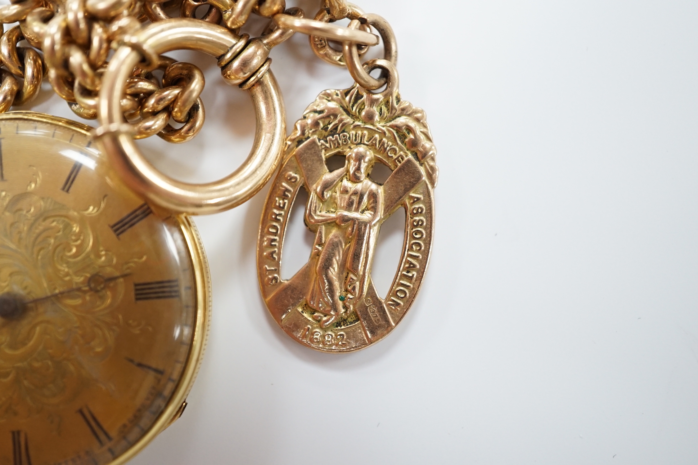 An 18k open face fob watch, with Roman dial, gross weight 38.5 grams, with key, together with a 9ct albert hung with a 9ct gold St. Andres Ambulance Association charm, gross weight 24.2 grams.
